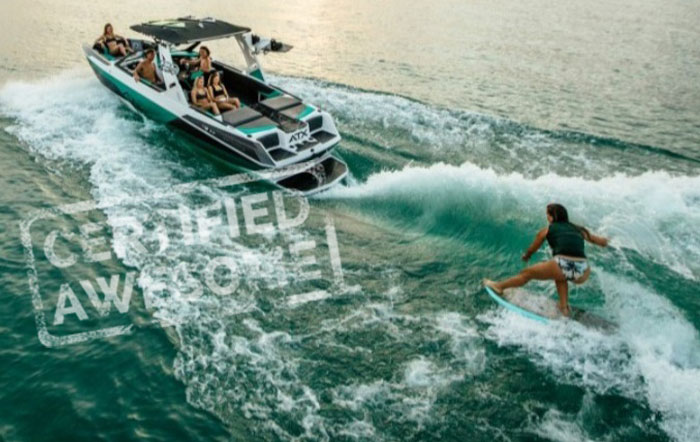 Girl wake surfing behind ATX Rental Boat